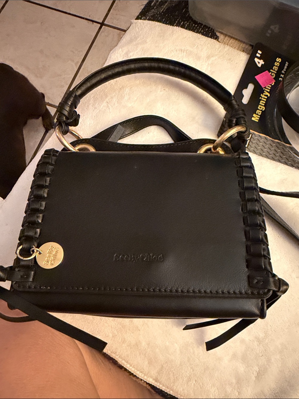 Black Satchel Handbag with Woven Edge and Gold Charm